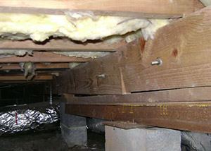 sagging crawl space with wooden shimming a  crawl space