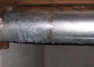 condensation collecting on an HVAC vent in a humid Brockport basement