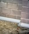 Our baseboard drain system installed on a corner in a Cortland basement.