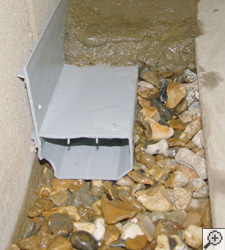 A no-clog basement french drain system installed in Pittsford