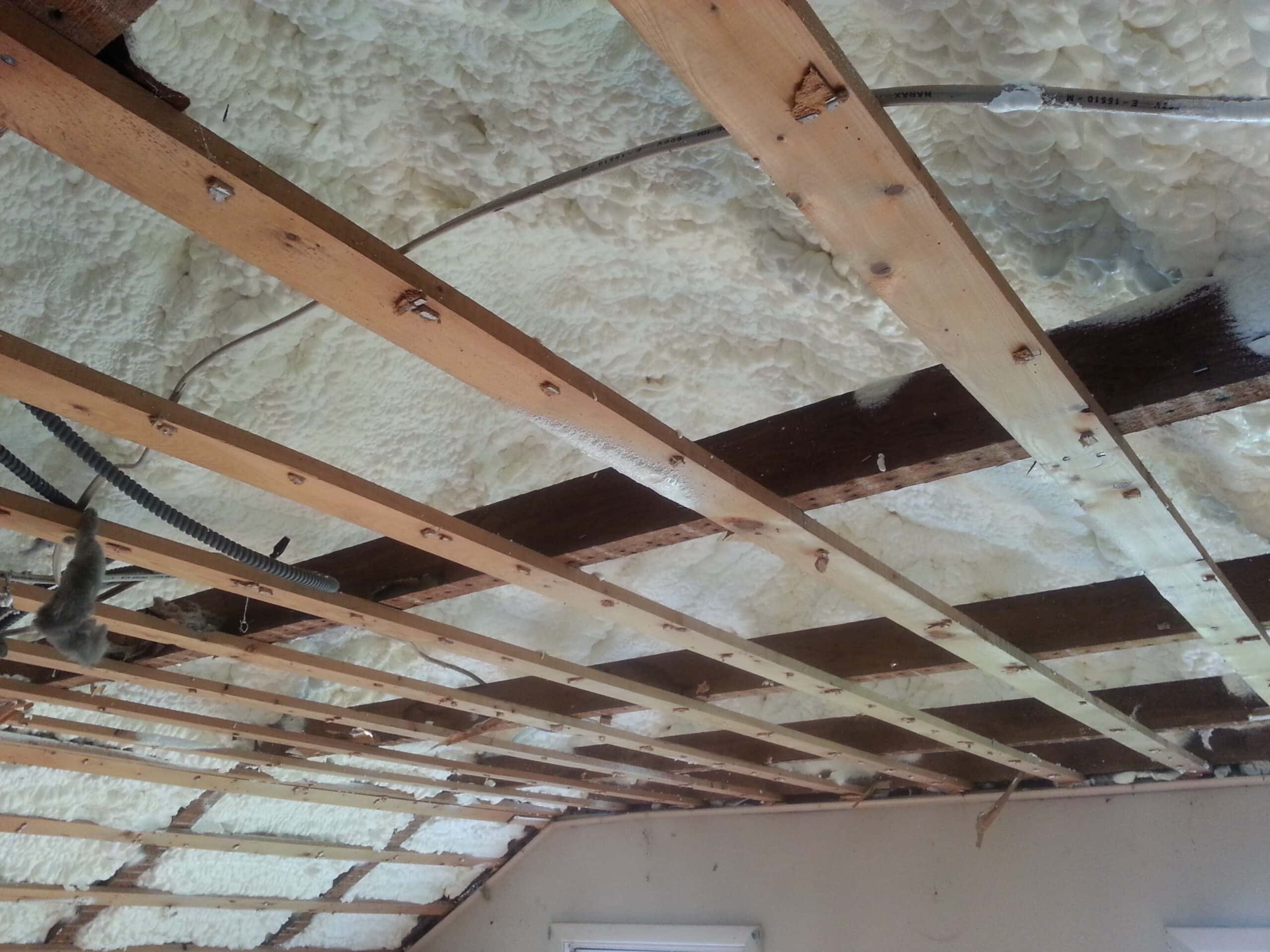 A shot of the spray foam insulation in the lower attic of this Syracuse, NY home.  Air can't easily escape through here, thus reducing the draftiness of the home!