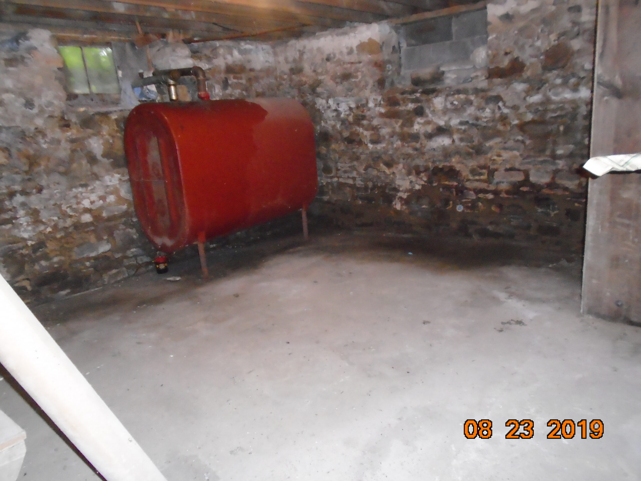 Notice the old oil tank and the moisture on the floor.