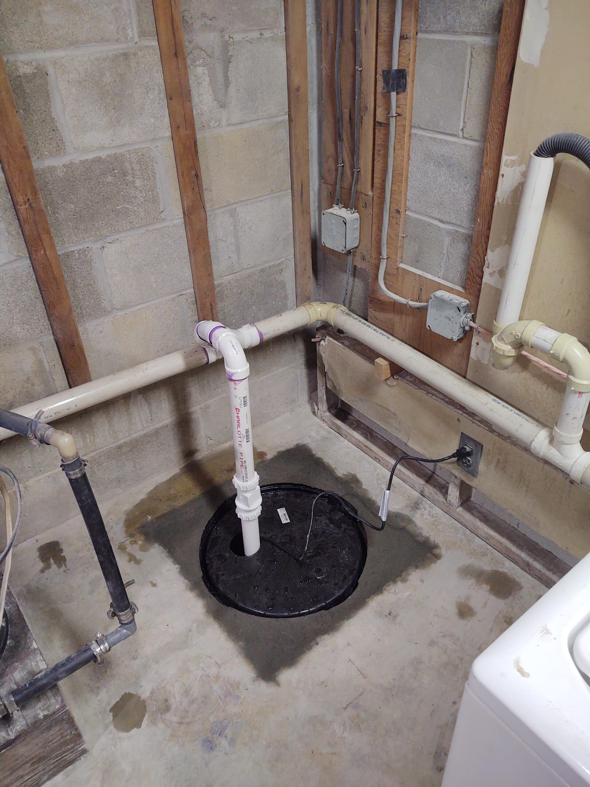 <p>The sump pump was installed and tested. You can see here that it was connected to an existing drain line. The lid was placed on the crock and the job is complete!</p>