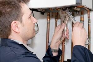 man working on boiler