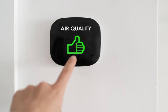 wall gadget that says "air quality" and has a green thumbs up underneath
