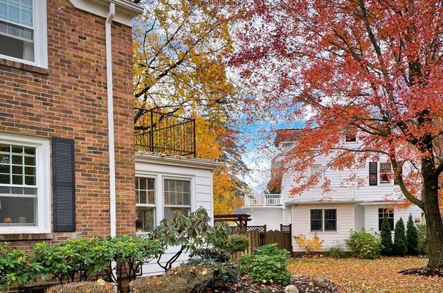 fall leaves outside of a brick house