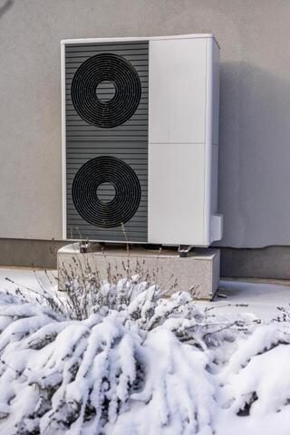 heat pump outside with snow on it