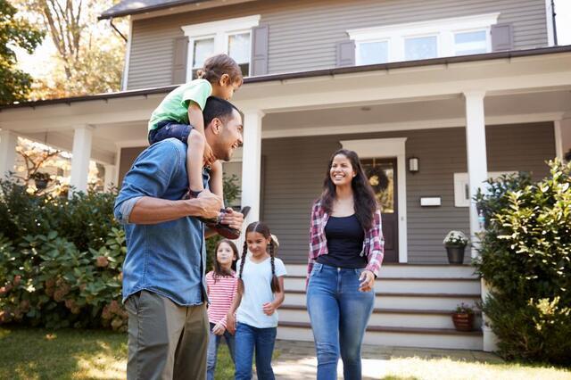 happy family in front of a house